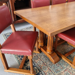 Set of eight Oak upholstered with faux leather dining chairs. They are in good original condition with only one chair having a slight tear in the upholstery as shown in photos.
