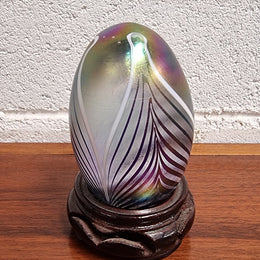 Iridescent glass egg shaped paper weight, on small wooden chinese stand. In good original condition. Please see photos as they form part of the description.