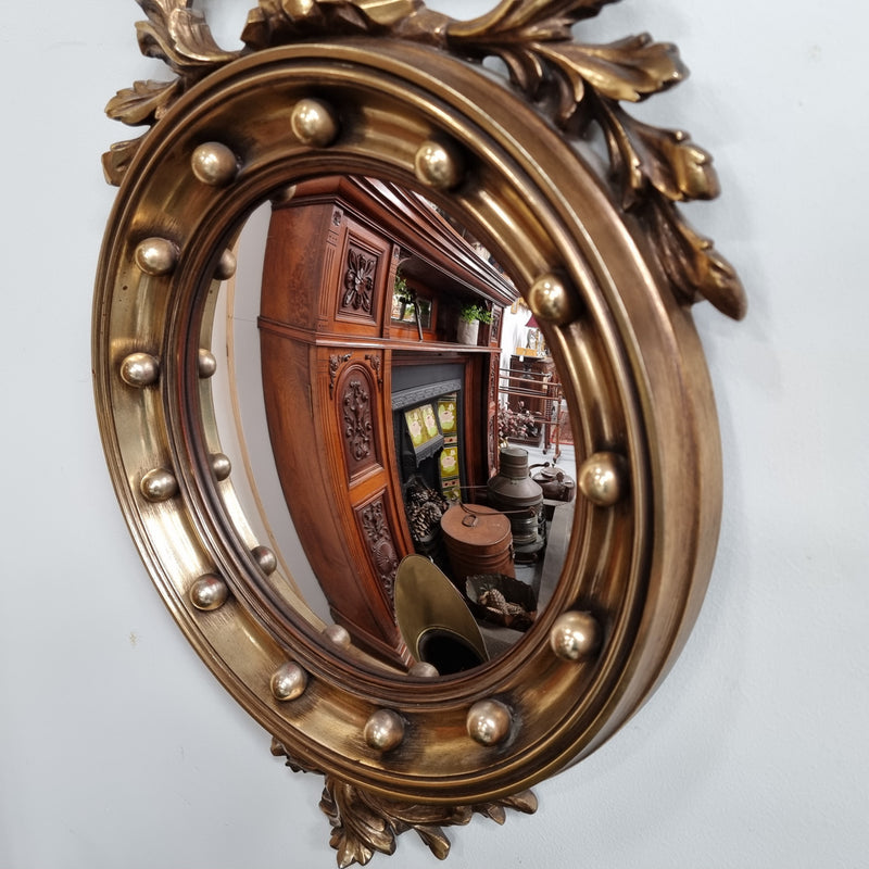 Vintage gilt framed convex mirror featuring carved eagle. It has been sourced from France and is in good original condition, please view photos as they help form part of the description.