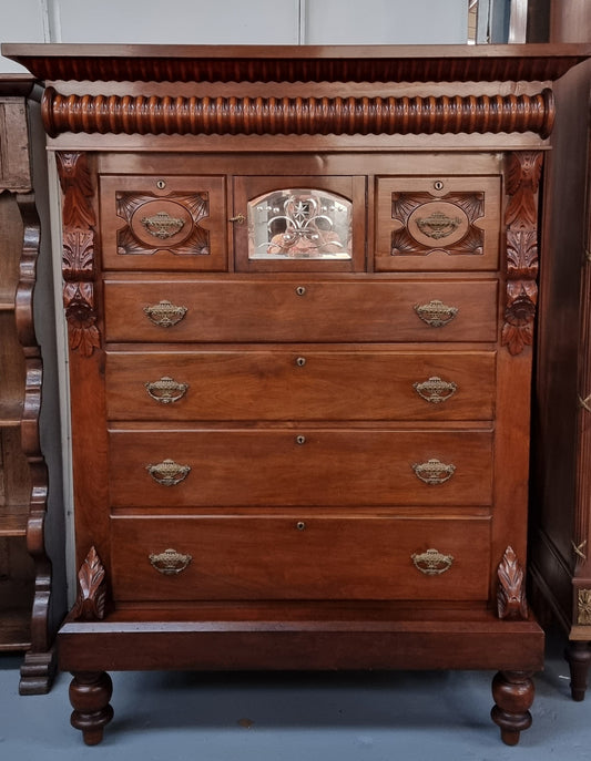 A 19th Century Scottish Mahogany tall boy/ chest of six drawers with small cabinet section at the top. Beautiful carvings and easily comes apart into three sections making transport for moving into place easy. In good original detailed condition.