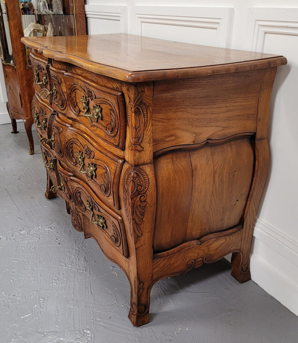 French Antique Louis XIV style Oak wooden top commode. It has a stunning serpentine bombe shape front along with amazing handles and carvings. It comes with three beautiful keys as pictured and comes with working locks. It has been sourced from France and in good original detailed condition.