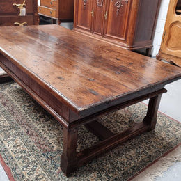Impressive large size rustic French Oak coffee table with two drawers on a stretcher base. In good original detailed condition and sourced from France.