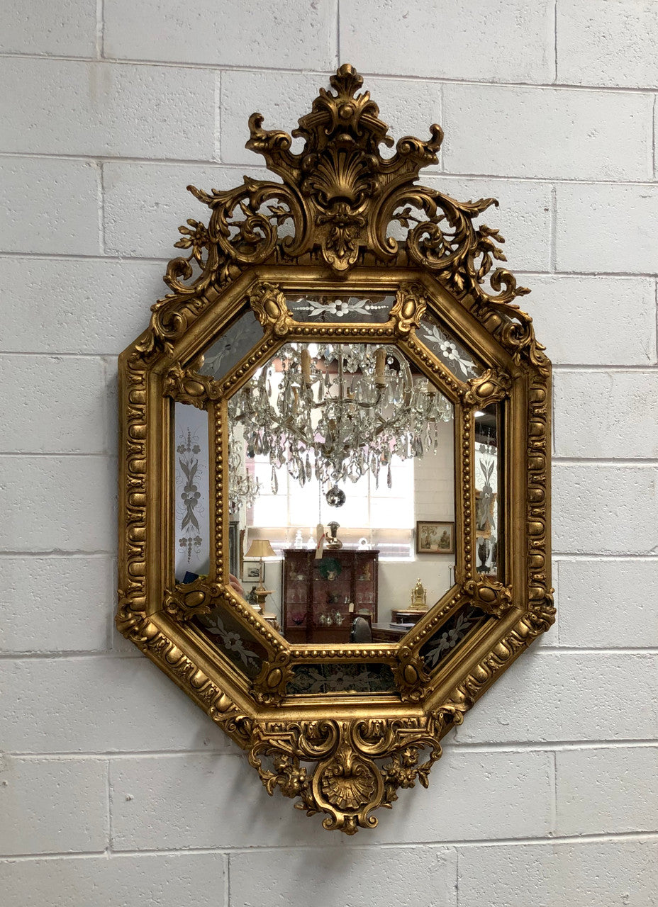 Early 19th Century gilt cushion mirror with acid etched floral pattern. In good condition. Please note original mirror does show some spotting commensurate with its age. Circa 1830's.