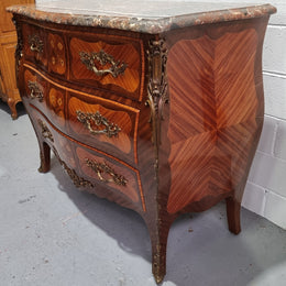 French Walnut and Kingwood Louis XV style marquetry inlaid commode with three drawers and a beautiful marble top. It is in good original detailed condition.