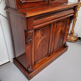Mid 19th Century Australian Cedar and Flame Cedar tall bookcase. The top has two glass doors that open up to three adjustable shelves followed by a drawer in the middle and finishes with two beautiful wooden doors that open up to a fixed shelf. In good original detailed condition and has been sourced locally.