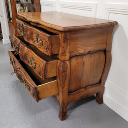 French Antique Louis XIV style Oak wooden top commode. It has a stunning serpentine bombe shape front along with amazing handles and carvings. It comes with three beautiful keys as pictured and comes with working locks. It has been sourced from France and in good original detailed condition.