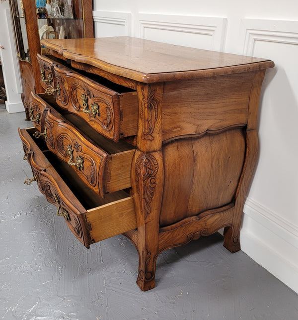 French Antique Louis XIV style Oak wooden top commode. It has a stunning serpentine bombe shape front along with amazing handles and carvings. It comes with three beautiful keys as pictured and comes with working locks. It has been sourced from France and in good original detailed condition.