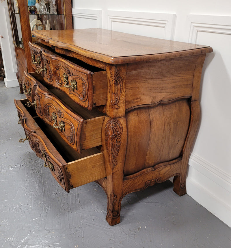 French Antique Louis XIV style Oak wooden top commode. It has a stunning serpentine bombe shape front along with amazing handles and carvings. It comes with three beautiful keys as pictured and comes with working locks. It has been sourced from France and in good original detailed condition.