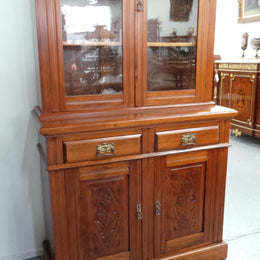 A beautiful Edwardian walnut stained bookcase with lovely carved doors and adjustable shelves. It is 227 cm tall and in very good fully restored condition.