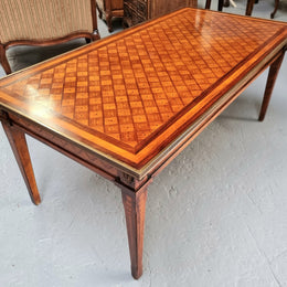 Beautiful French Louis XVI style inlaid coffee table with a brass band and glass top. In good original detailed condition.