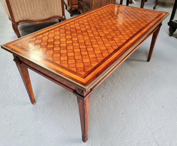 Beautiful French Louis XVI style inlaid coffee table with a brass band and glass top. In good original detailed condition.