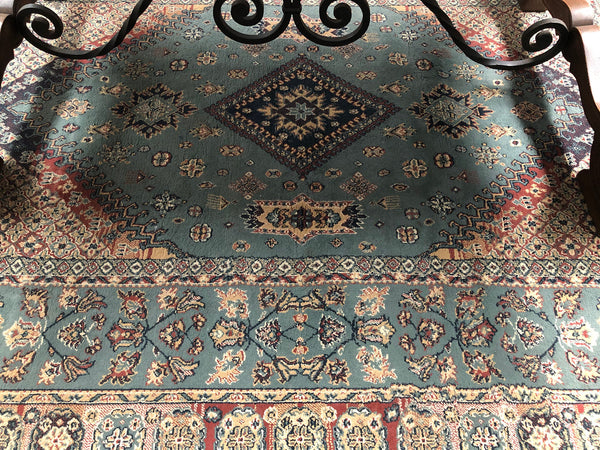 A beautiful coloured Turkish Rug with shades of green, teal, navy and rust in good condition.