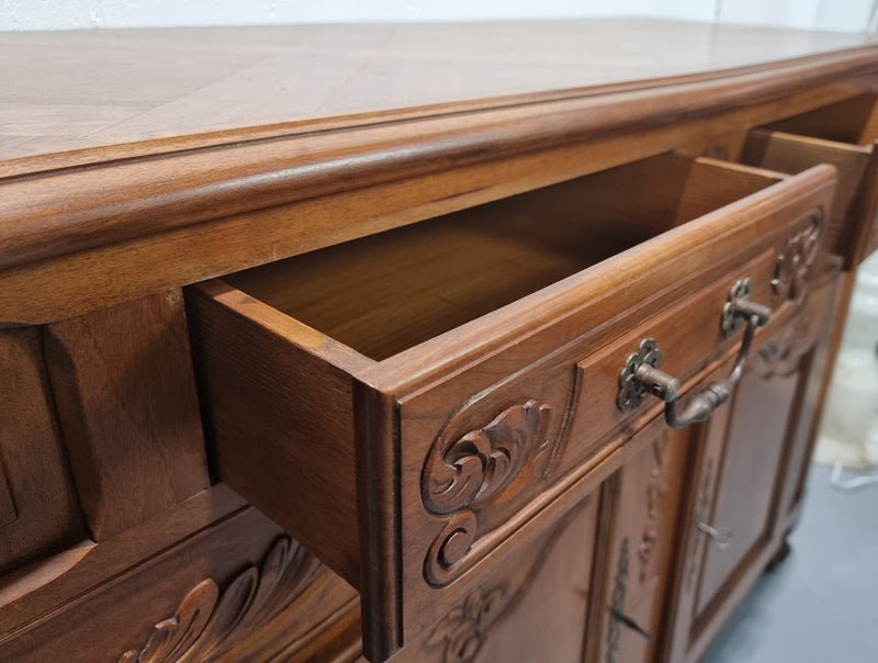 French Walnut two door buffet with parquetry top. It has two drawers and an adjustable shelf. In good original detailed condition and it has been sourced from France.
