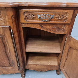 Parquetry top French oak Louis XV style sideboard with two draws and four cupboards. In good original detailed condition.