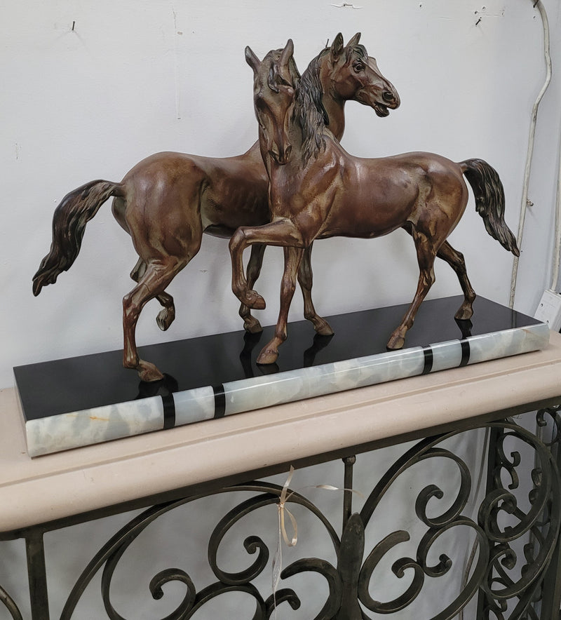 Art Deco patinated bronze French spelter horses on a stunning marble base. It is in good original detailed condition.