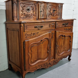 Stunning 19th Century French Walnut Buffet à Glissant from Provence, France. This is an exceptional charming piece and very functional with plenty of storage space, two large cupboards at the bottom, two drawers in the middle and two sliding doors either side at the top and finished off with a small central cupboard. In good original detailed condition.
