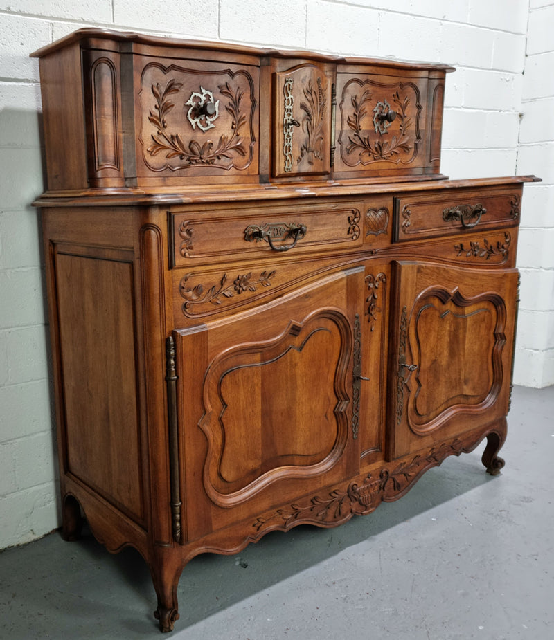 Stunning 19th Century French Walnut Buffet à Glissant from Provence, France. This is an exceptional charming piece and very functional with plenty of storage space, two large cupboards at the bottom, two drawers in the middle and two sliding doors either side at the top and finished off with a small central cupboard. In good original detailed condition.