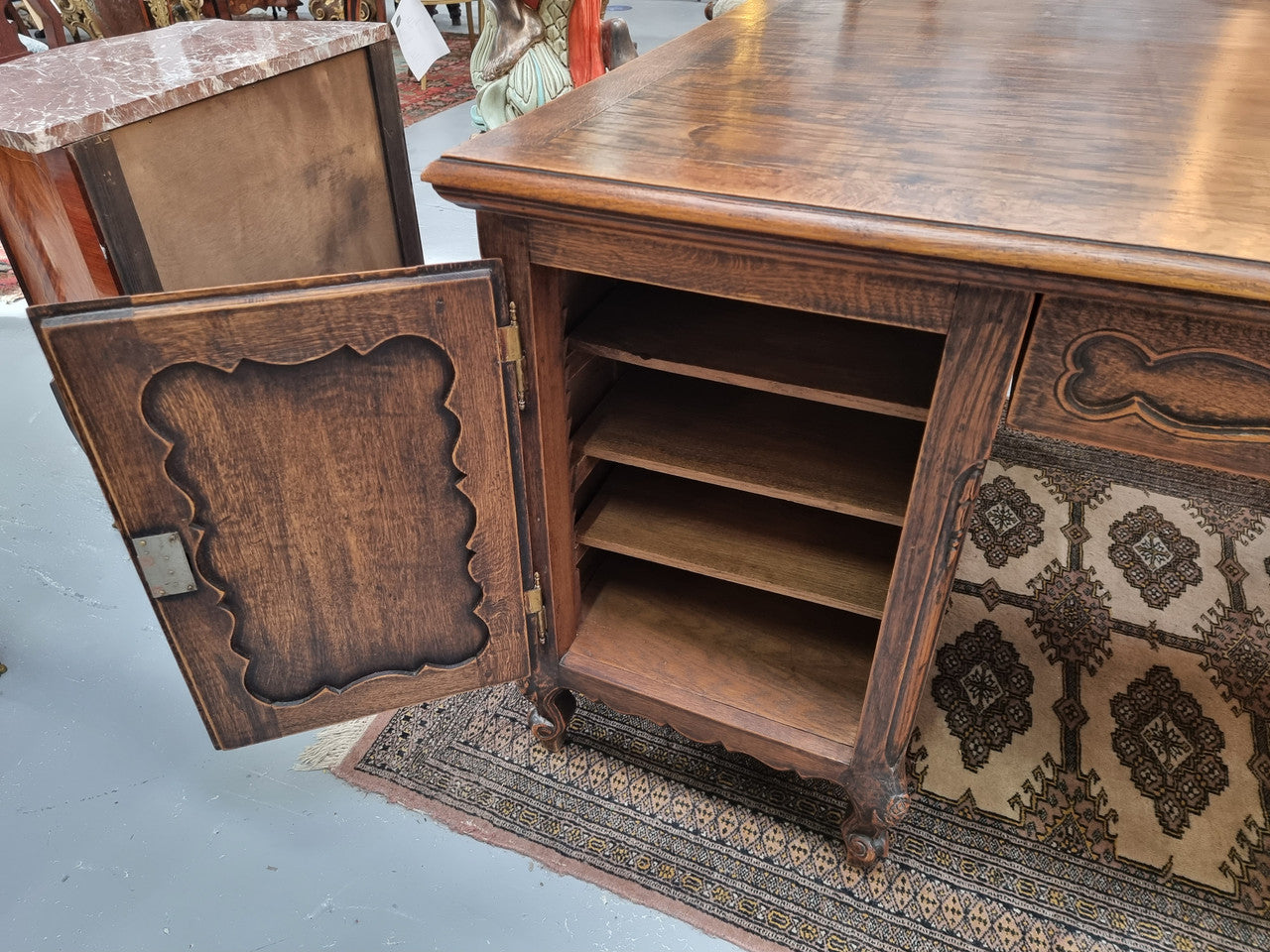 Fabulous Louis XV style French Oak beautifully carved full partners desk. Both sides have a functioning drawer in the middle and two cupboards either side. On both sides one cupboard door opens up to four smaller internal drawers. Plenty of storage space and a large top surface to work on. It is in good original detailed condition.