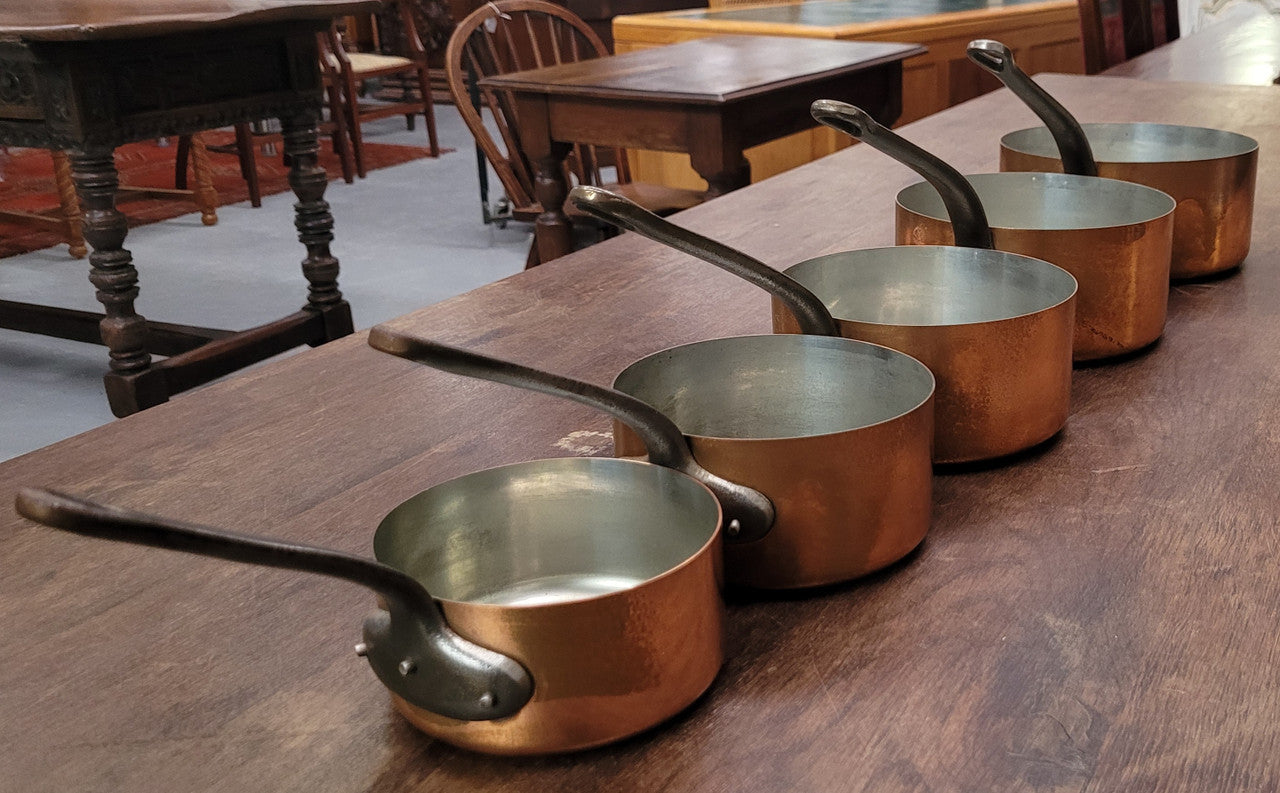 Set of five copper sauce pans with foundry stamp. They have been sourced from France and are in good original detailed condition.
