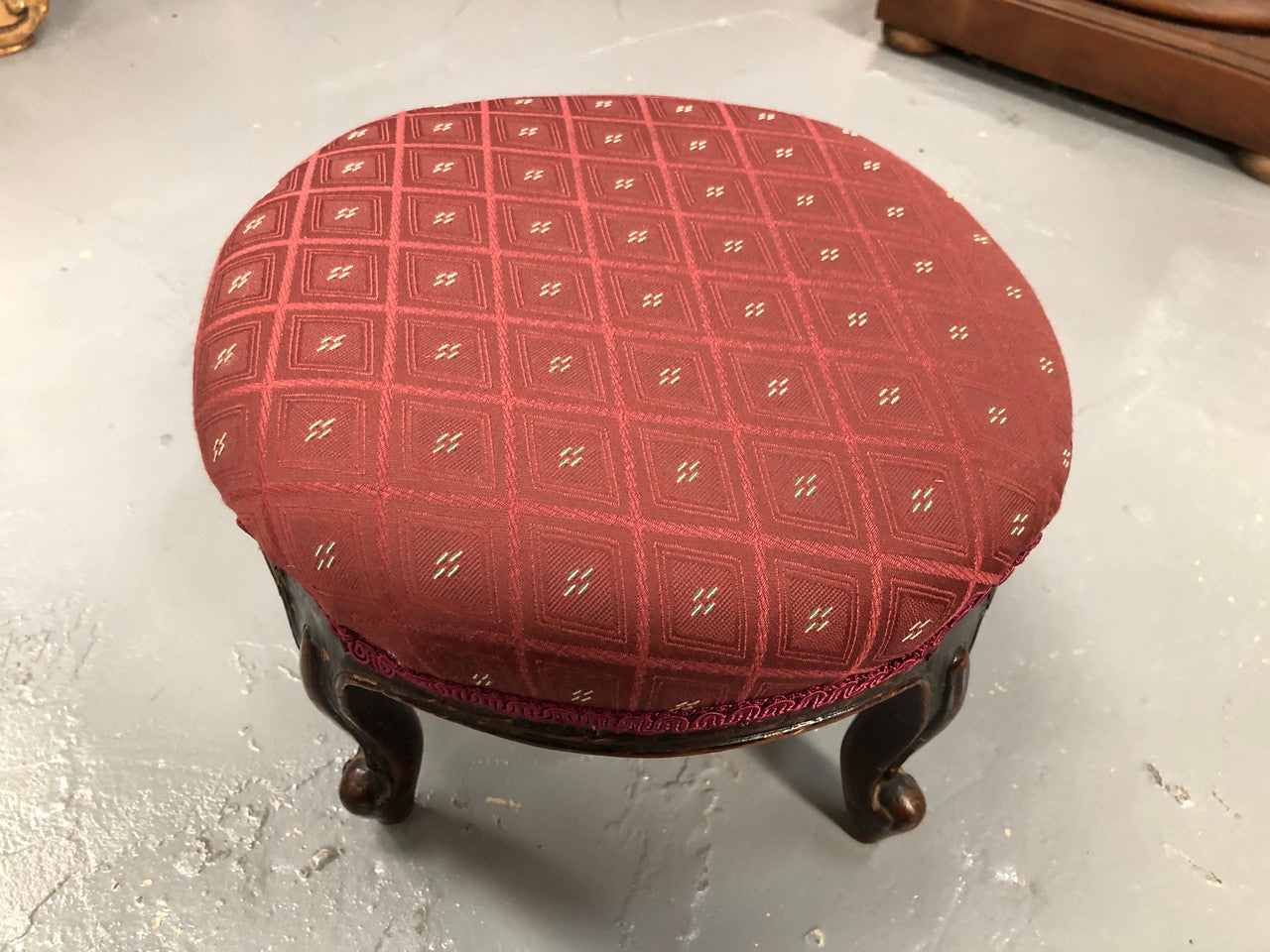 Upholstered Antique Mahogany round foot stool with beautiful carved feet. In very good original condition.