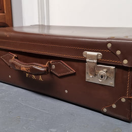 Impressive solid leather suitcase, moire fabric lined with leather straps to hold contents. Displays gold initials F.S.A near handle. With key. Please view photos as they help form part of the description.