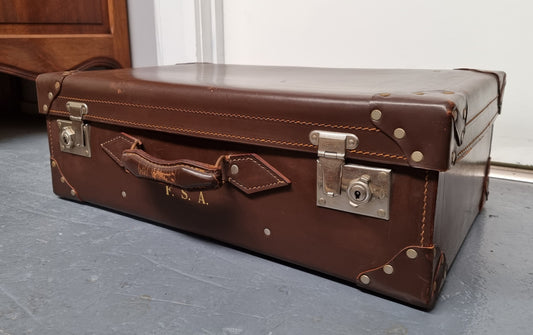 Impressive solid leather suitcase, moire fabric lined with leather straps to hold contents. Displays gold initials F.S.A near handle. With key. Please view photos as they help form part of the description.