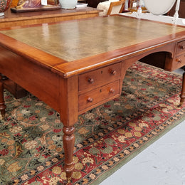 Australian Cedar full partners desk with attractive tooled leather top, four drawers either side and on caster wheels.  In good original detailed condition.