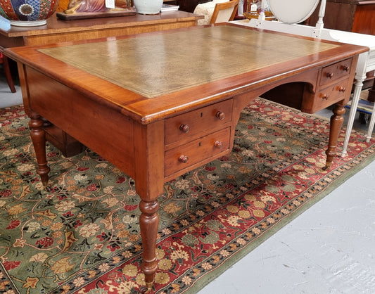 Australian Cedar full partners desk with attractive tooled leather top, four drawers either side and on caster wheels.  In good original detailed condition.