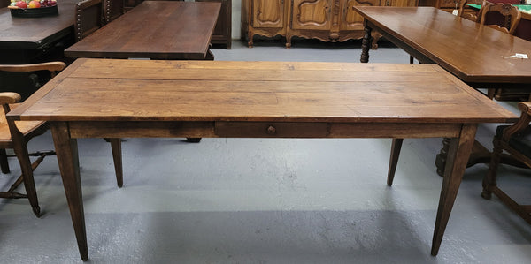 Provincial 19th Century French Oak rustic farmhouse table with tapered leg and single drawer. It has been sourced from France and is in good original detailed condition. 