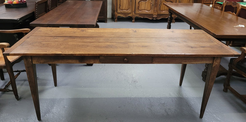 Provincial 19th Century French Oak rustic farmhouse table with tapered leg and single drawer. It has been sourced from France and is in good original detailed condition. 