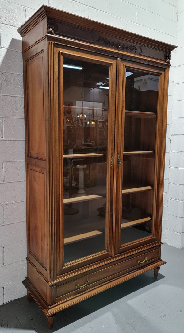 Stunning French Henry II style Walnut two door bookcase. In good original detailed condition.