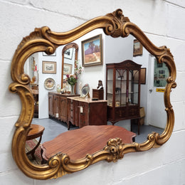 French Louis XV style wood carved and gilded mirror. Mirror is original and showing signs of age. It has been sourced from France and  in good original condition.