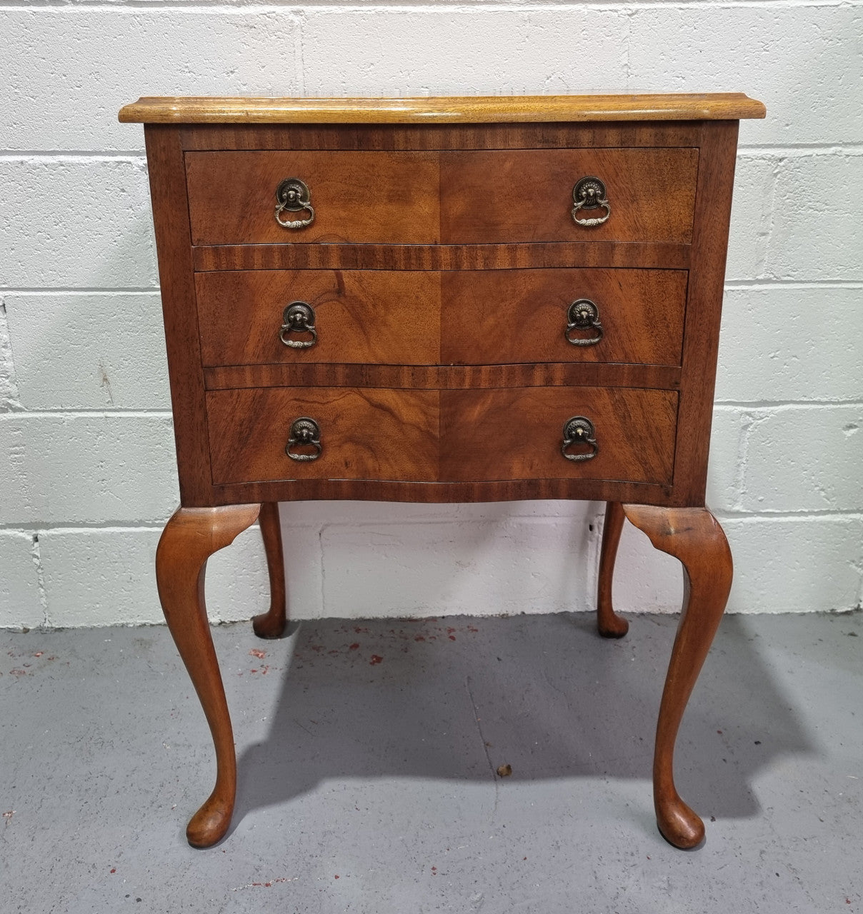 Antique Queen Anne style figured Walnut Bedside cabinet with 3 drawers. It is in good original detailed condition.