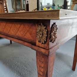 Beautiful French Louis XVI style inlaid coffee table with a brass band and glass top. In good original detailed condition.