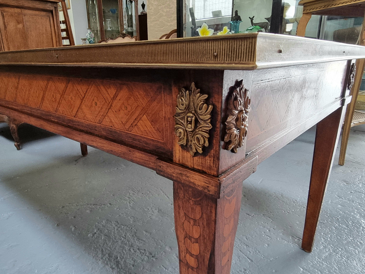 Beautiful French Louis XVI style inlaid coffee table with a brass band and glass top. In good original detailed condition.