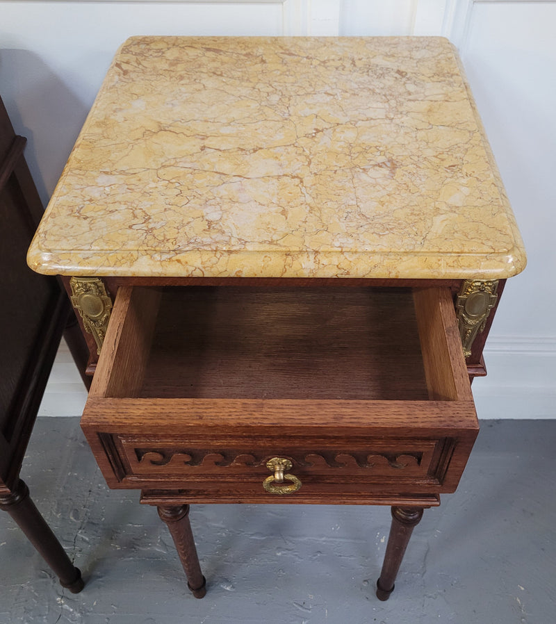 French Oak pair of Louis 16th style marble top bedsides with stunning bronze mounts. They have been sourced from France and are in good original detailed condition.