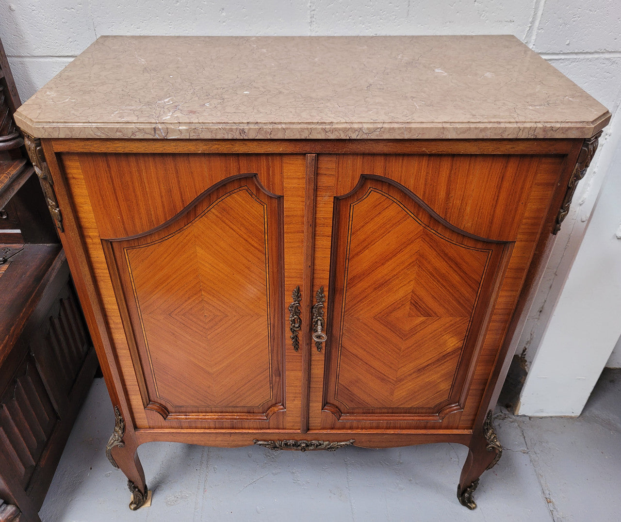 Stunning compact Louis 15th style two door walnut cabinet with ormolu trim and marble top. It is in good original condition.