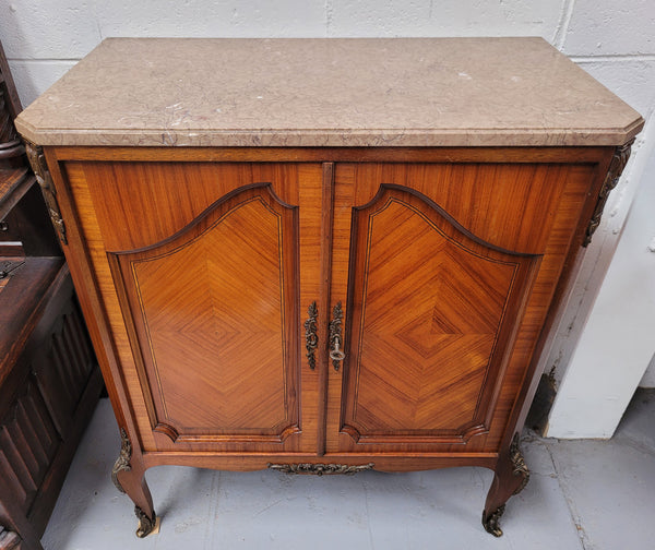 Stunning compact Louis 15th style two door walnut cabinet with ormolu trim and marble top. It is in good original condition.