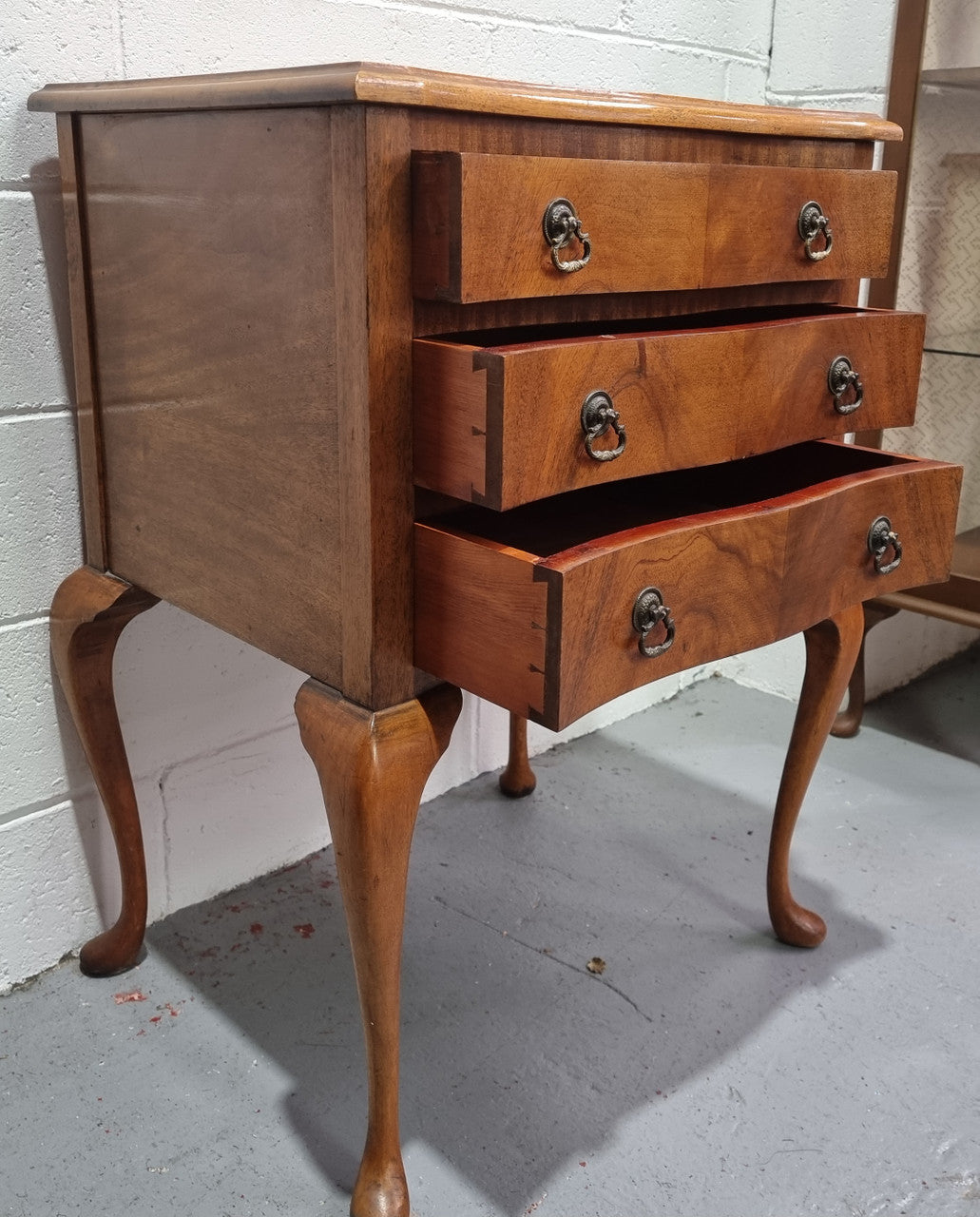 Antique Queen Anne style figured Walnut Bedside cabinet with 3 drawers. It is in good original detailed condition.