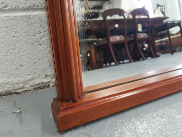 Art Deco mahogany mirror of long and narrow portions. In good original condition and retaining it's original mirror.