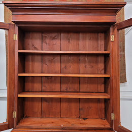 Mid 19th Century Australian Cedar and Flame Cedar tall bookcase. The top has two glass doors that open up to three adjustable shelves followed by a drawer in the middle and finishes with two beautiful wooden doors that open up to a fixed shelf. In good original detailed condition and has been sourced locally.