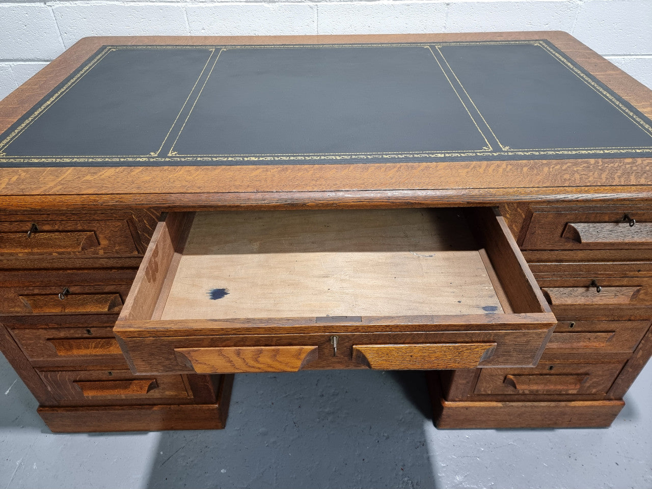 Amazing American Oak full partners leather top desk. Plenty of storage space with nine drawers on one side and two cupboards of the oppsite side. It is in good restored condition and has a new leather and gold tooled inset top.