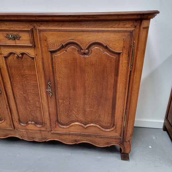 Amazing French Oak early 19th Century two door sideboard with one drawer and two fixed shelves. Sourced from France and in good original detailed condition.