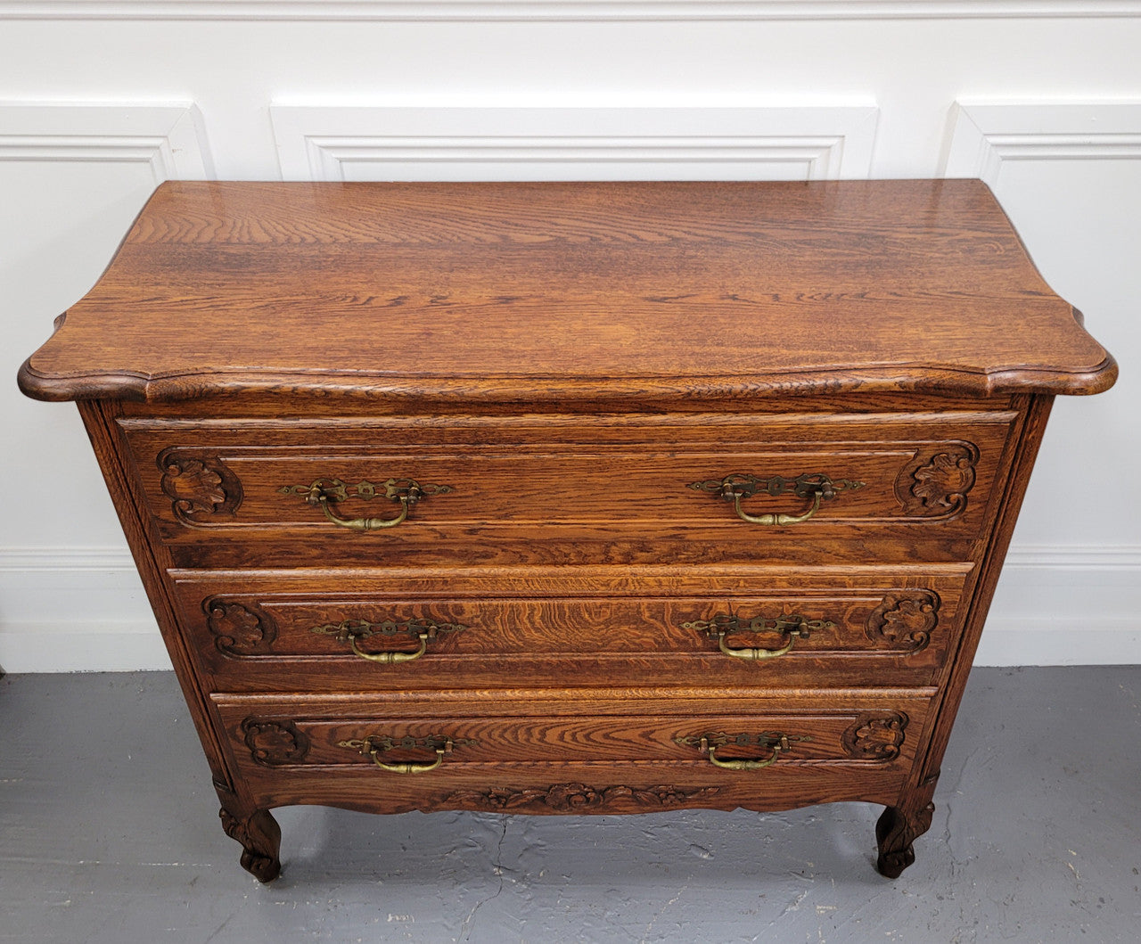 French Louis XV style Oak three drawer chest with wooden top. It has been sourced from France and is in good original detailed condition.