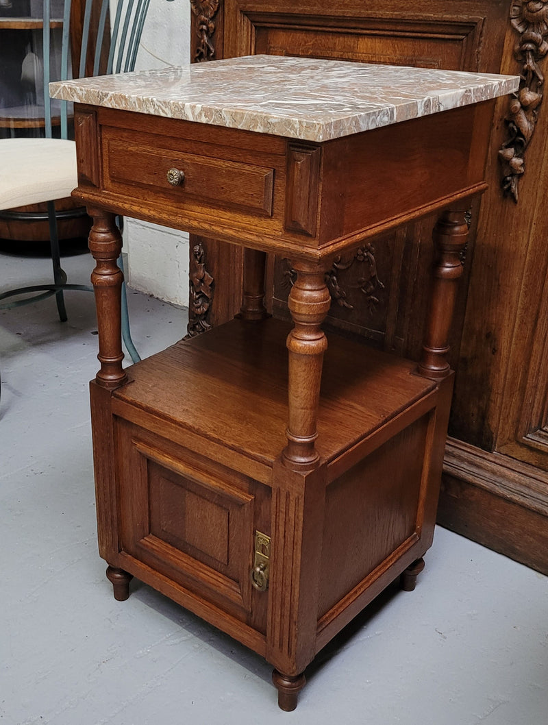 Pair of French Antique Oak marble top bedsides Henry II style. They have a drawer, cupboard and an open shelf for all your storage needs. They have been sourced from France and are in good original detailed condition.