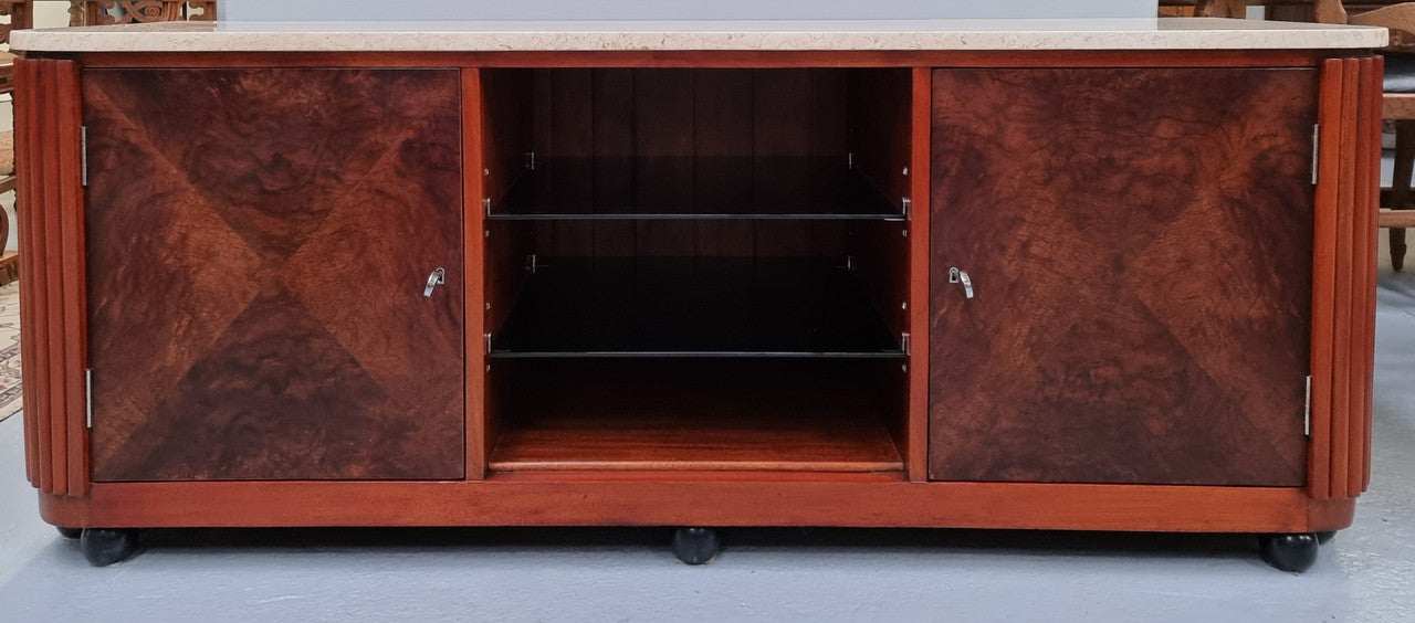 Beautiful Bespoke Art Deco style walnut and mahogany low line cabinet with a marble top and plenty of storage. It has two doors with a shelf each side and in the middle in has two glass shelves. Would make an ideal TV cabinet and has a hole in the back to run cords through. In very good original detailed condition.