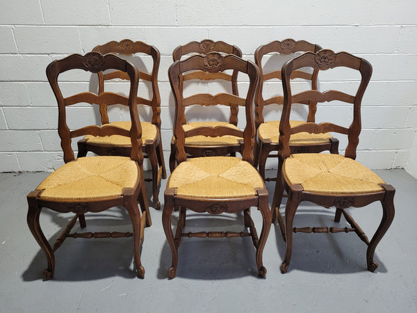 A stunning set of six French Louis XV Style oak dining chairs with rush seats in good original condition. All chairs have been detailed and re-glued where needed.