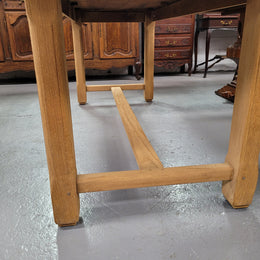 French raw Oak stretcher based refectory table. Features raw wood that could be used as is for a distressed look, or finished and waxed for a more refined look. Sourced from France and in good original condition.