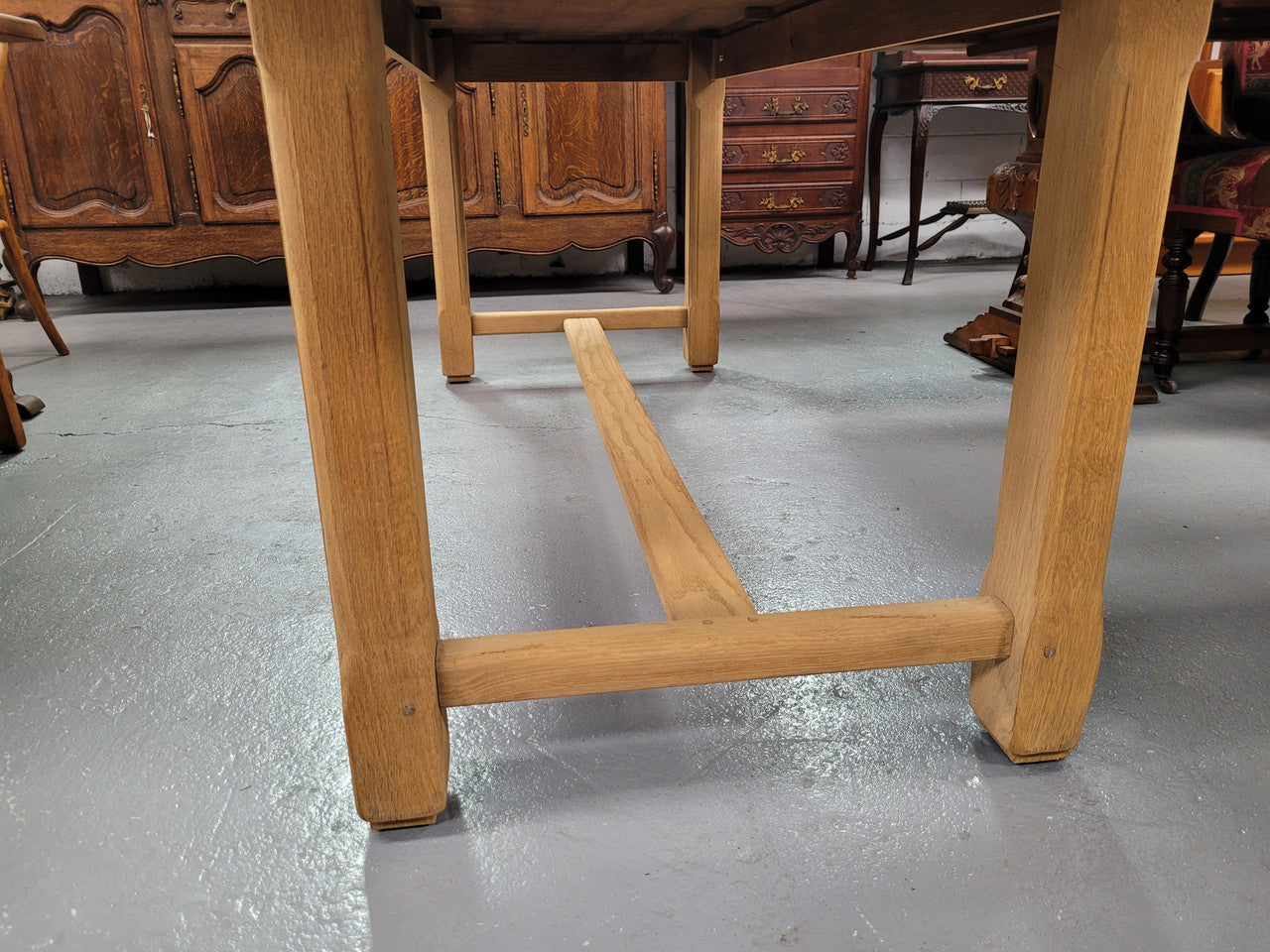French raw Oak stretcher based refectory table. Features raw wood that could be used as is for a distressed look, or finished and waxed for a more refined look. Sourced from France and in good original condition.