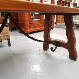 French Oak Spanish style dinner table with beautiful simple iron work underneath. Table top is in good original condition with character marks and has a wax finish. Circa 1930.